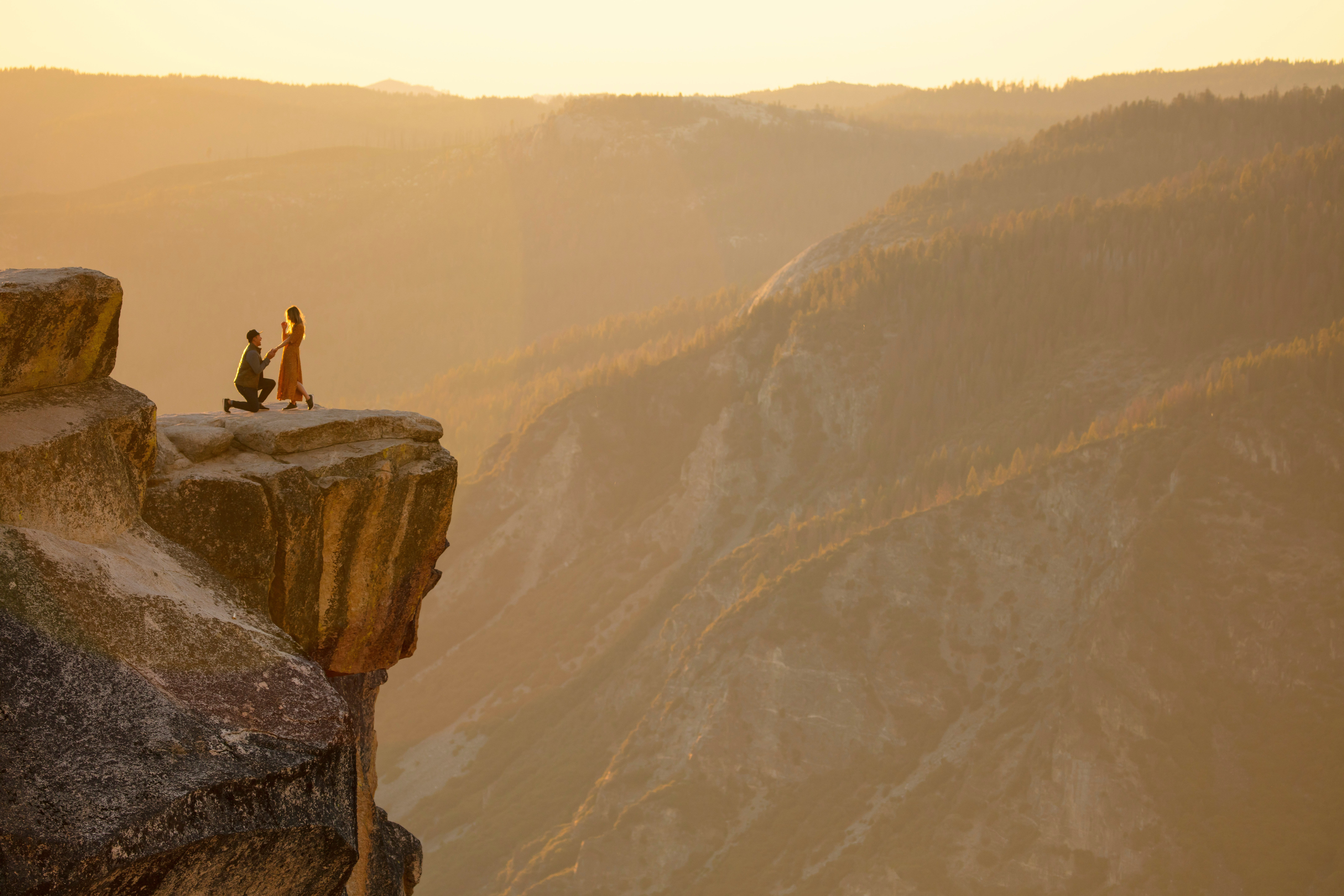 A cliff-top couple getting engaged